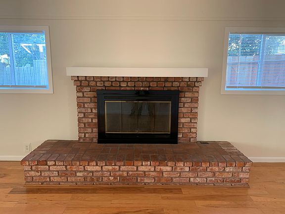The fireplace from back wall. Room is 19'4 long x 12'3 wide Looks out into the side private yard area.