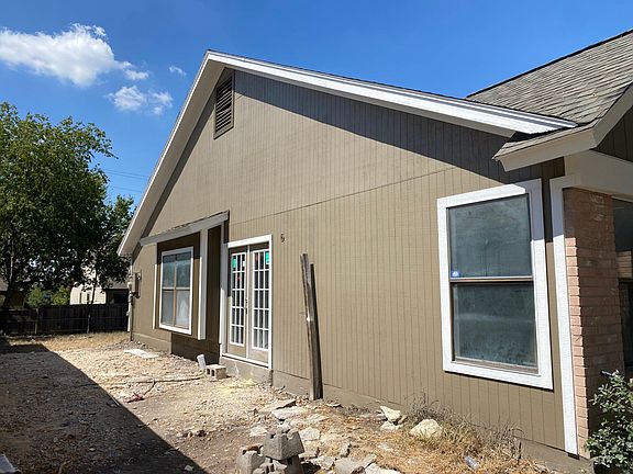 Large side yard with new 10ft x 10ft concrete patio pad just outside new French doors.
