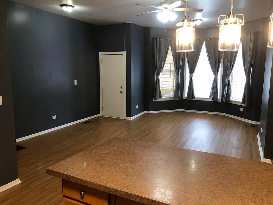 View of common area with lots of space and natural light. Fresh paint throughout the apartment.
