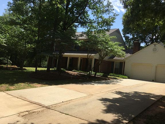 Front of house. Long drive and attached garage