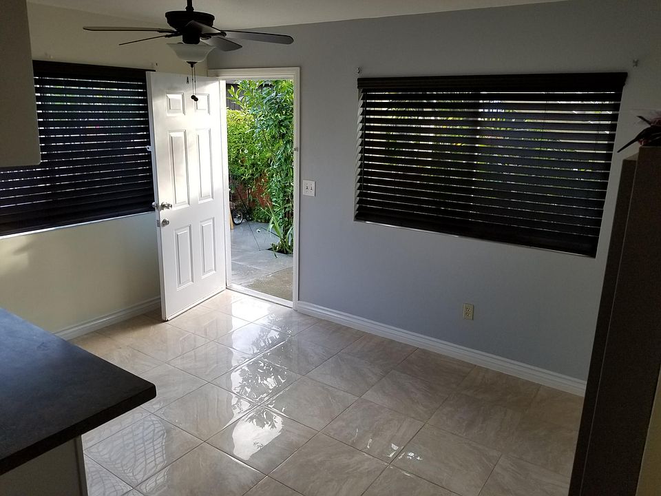 Front entrance and living room with ceiling fan and tile flooring. Heater shown on the right.