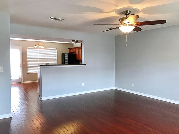 Large open living area, hardwoods, half bath.