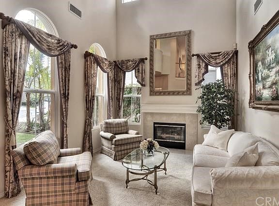 Formal living room with soaring ceilings and fireplace