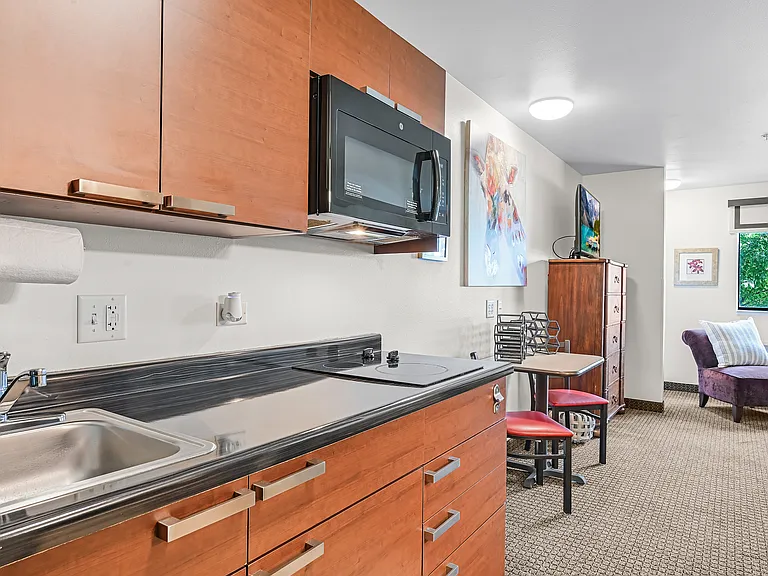 Kitchens include full sized fridge, cooktop range, and microwave.
