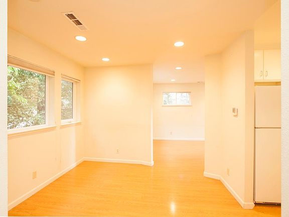 Sunny and airy dining area adjacent to living room and the kitchen