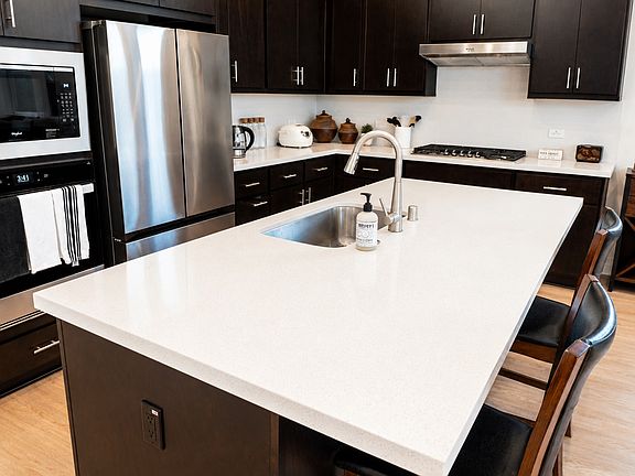 Microwave, Oven, Full Size Refrigerator, Large Kitchen Island with Sink, Gracious Cabinets and Drawers.