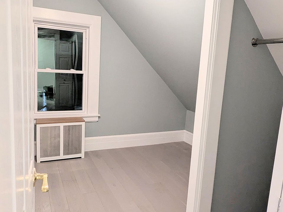 Second bedroom on the top floor with enough room for a full or twin bed, and brand new hardwood oak flooring.