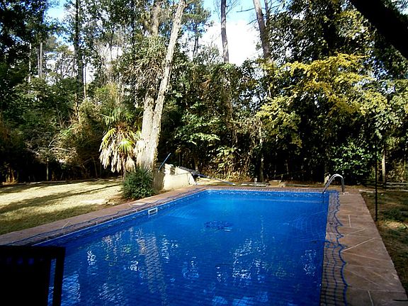 In ground swimming pool including a kitty catcher child safety net. This pool is in the center of th