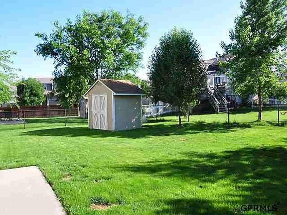 Fenced backyard with shed.