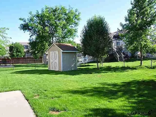 Fenced backyard with shed.