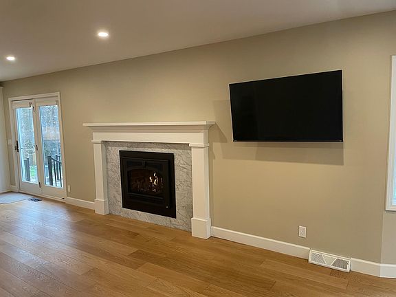 Great room, TV can be viewed in living or kitchen areas. Gas stove insert provides wonderful heat in the winter.