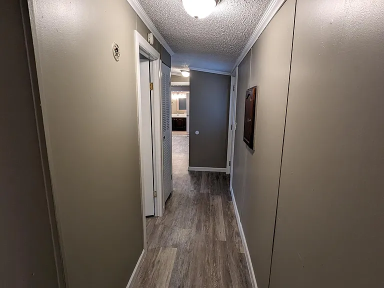 hallway to washer dryer, rear deck and 3 bedrooms