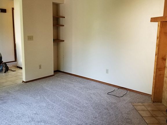 family room with wood burning fireplace and built in shelves