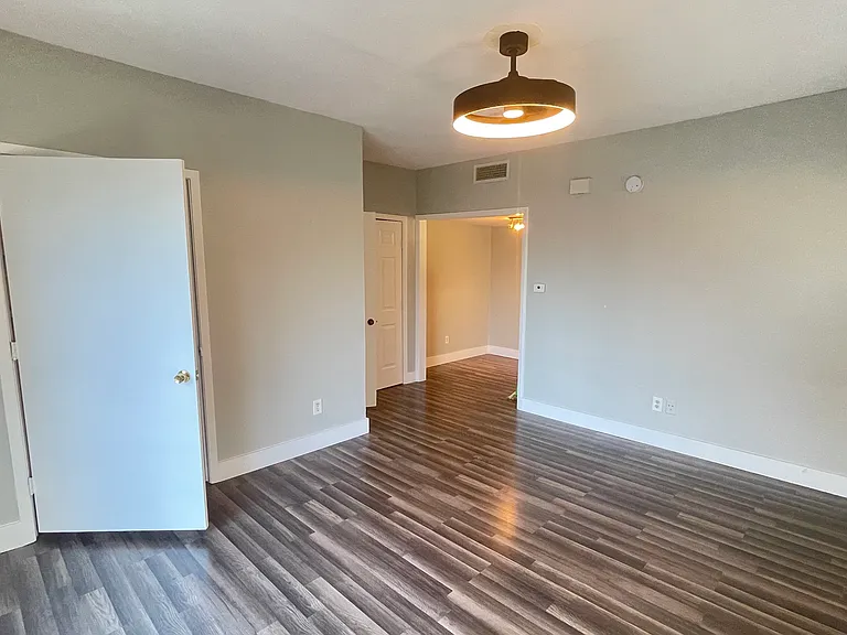 View of living/sleeping area toward the dedicated dining space and front entry.