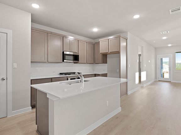 Kitchen in the Willow home plan by Trophy Signature Homes - REPRESENTATIVE PHOTO