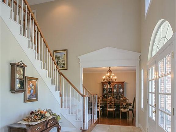 Main hall entry with pretty staircase - formal dining room to the right