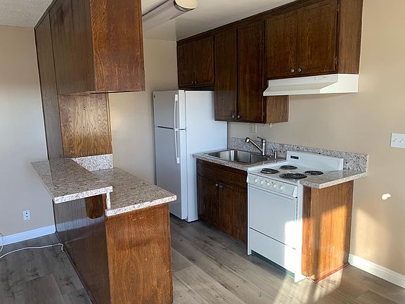 Kitchen includes refrigerator & electric stove