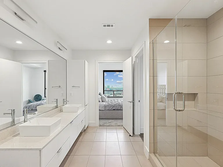 Elegant Modern Bathroom with Dual-Sink Vanity and Glass-Enclosed Shower