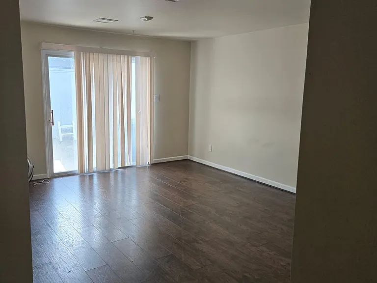 Large living room this view is facing back sliding doors overlooking back yard/patio area and covered parking area.