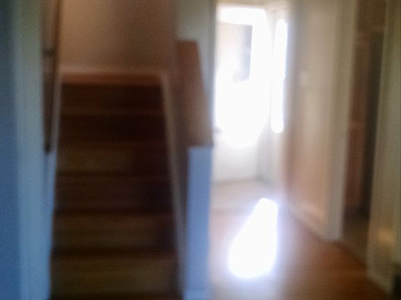 Looking toward entryway and up stairs