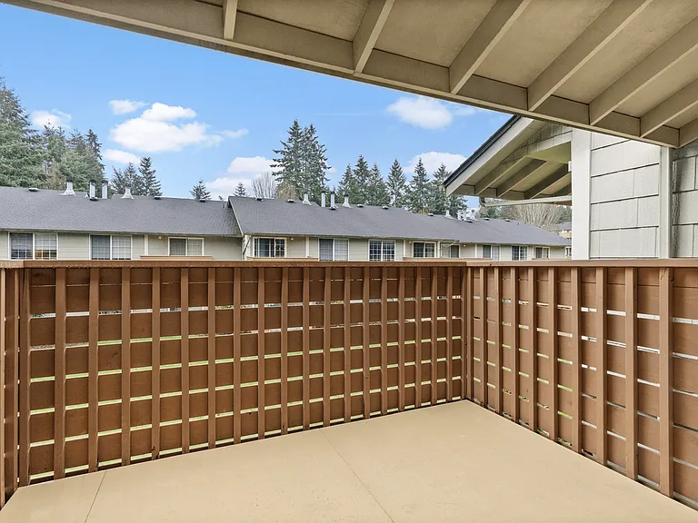 Relax on your private balcony with peaceful community views.
