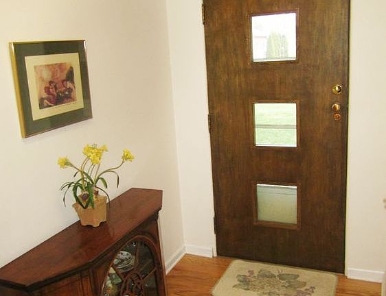 Welcoming front entry with newer wood flooring.