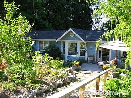 Lovely home in forested area
						:
						Home surrounded by many beautiful trees, front has established perennial garden.