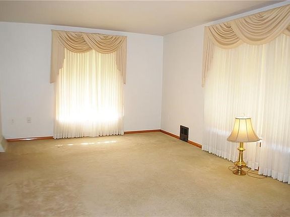 Large (20x11) living room with hardwood floors under carpet.