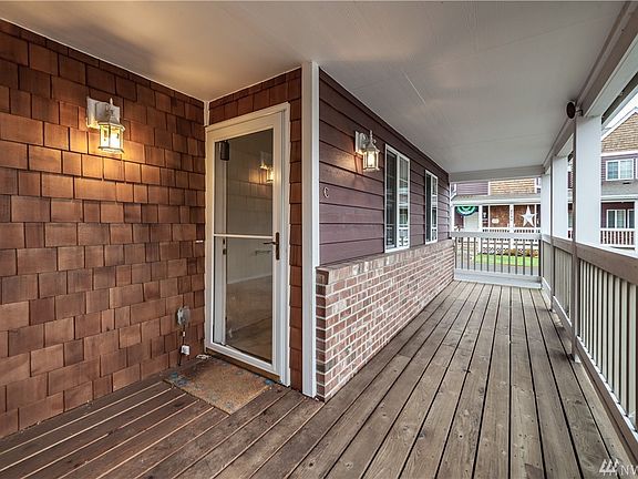 A nice view of the covered porch in front of the home, with plank flooring.