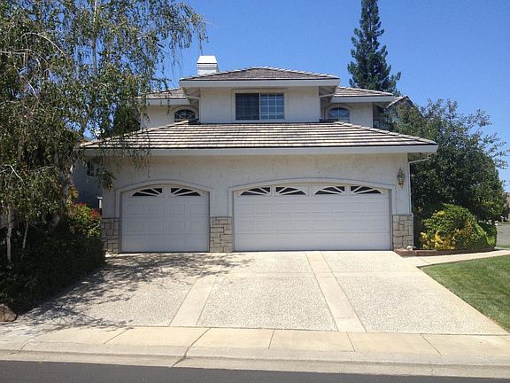 3 car garage, front door to the right pathway