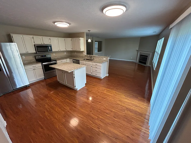 Open concept floorplan with kitchen, dining and living rooms on the 1st floor