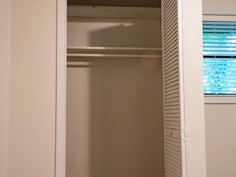 Each closet, such as this one on the south wall, features a clothes rod and shelves. Now let's look at the master bathroom.
