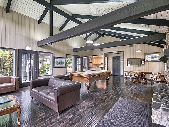 Recreation Room with a pool table, television and fireplace with a full kitchen equipped with a stove/oven and refrigerator