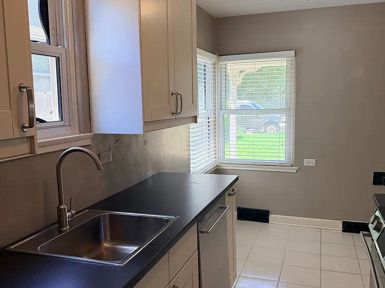 The eat-in kitchen has a sunlit area big enough for a table and 4 chairs under the windows. Recently installed appliances, and cabinets were recently updated.