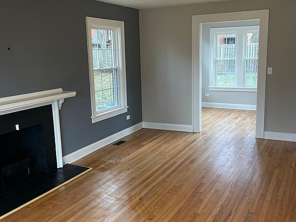 Large family room with fireplace, leading into a perfect office space with lots of natural light for the remote worker