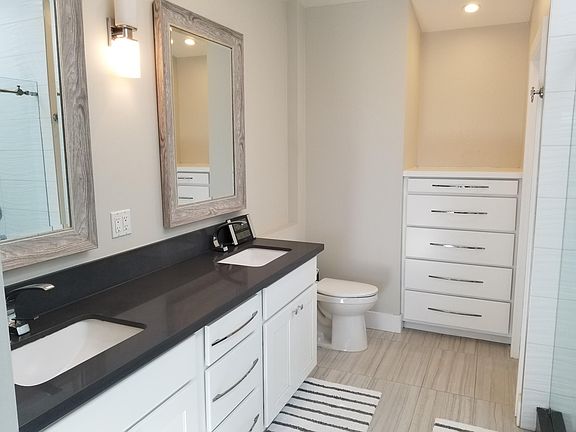 Master Bath with double sinks, walk-in closet, and storage drawers