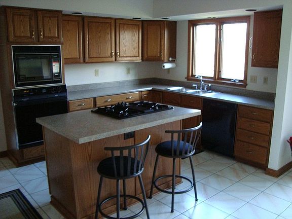 Huge gourmet kitchen with center island, separate eating area,  deck/menu area
