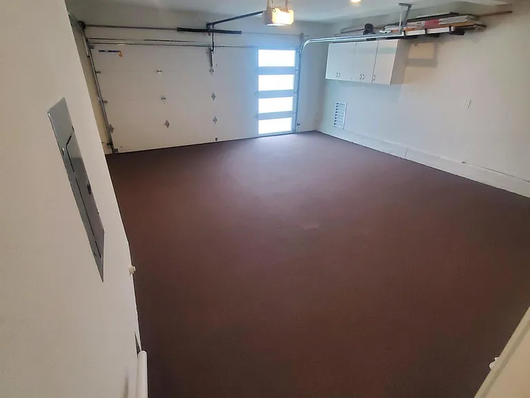 Double car garage for two vehicles. With in door out door carpet and storage area.
