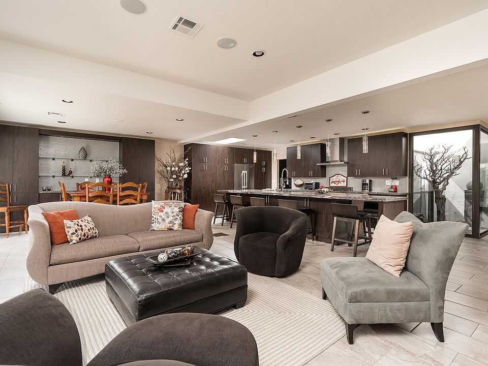 Great Room Style floor plan; showing combined living, dining, kitchen and atrium areas.