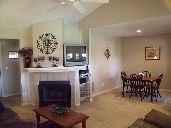 Beautiful living room with woodburning fireplace,neutral paint/carpet 