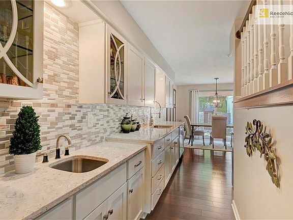 Marble counter tops, glass front cabinets and wet bar are a great addition to the kitchen.