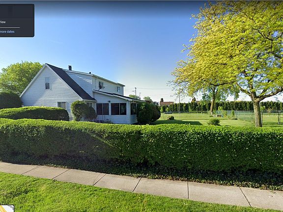 Large backyard with privacy bushes.