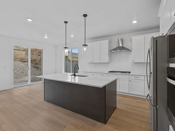 The kitchen has a beautiful matte black Moen faucet.
