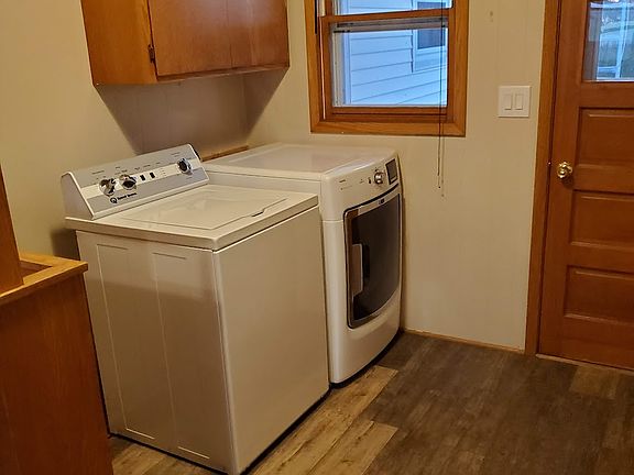 Here you see the washer and dryer with nice cabinets above them. They are on the main floor...how convenient is that? The door you see in the picture goes outside to the backyard.
