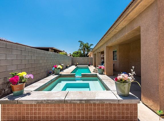 Relaxing Spa with cascading waterfall into pool