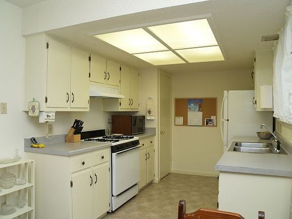 Large galley-type kitchen with windows, diswasher & disposal.