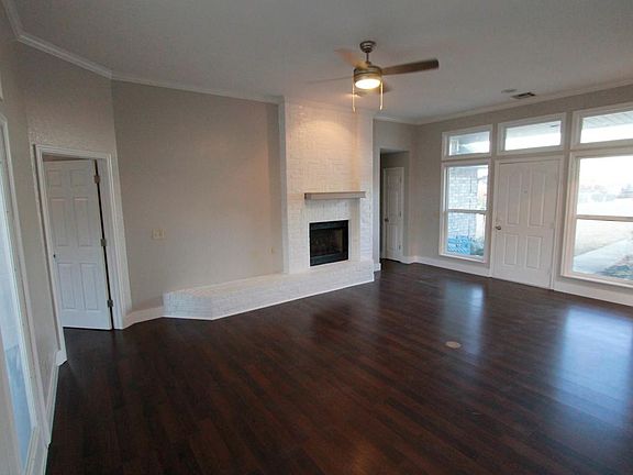 Large open living room, brick fireplace