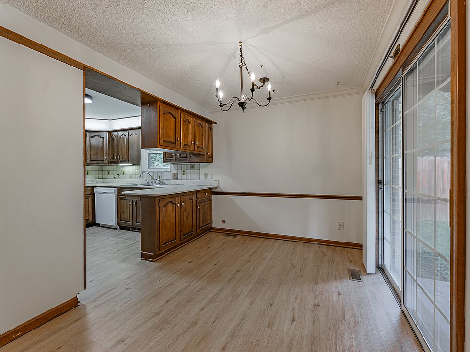 Dining room with sliding glass door to fenced in backyard