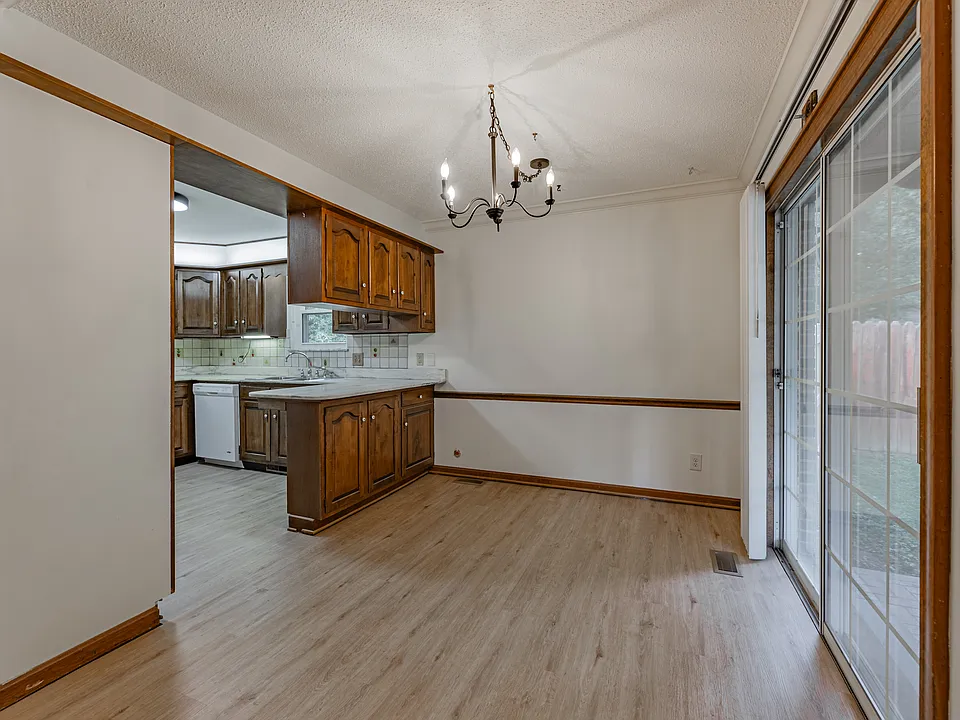 Dining room with sliding glass door to fenced in backyard