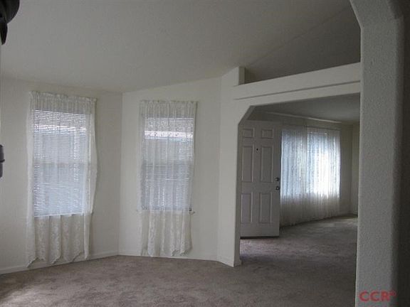 Formal dining room with opening above the entry.